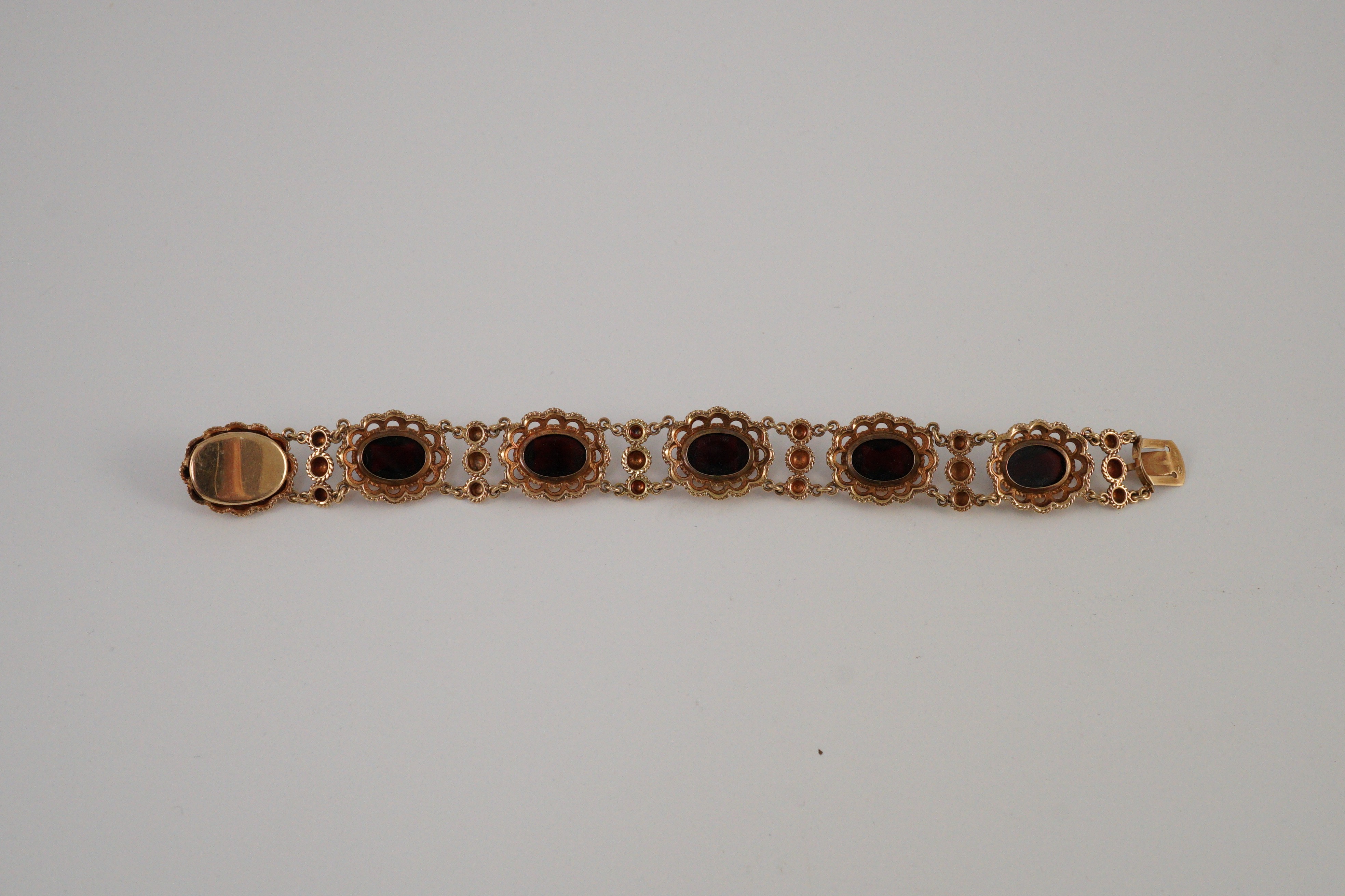 A 20th century Dutch 14k gold and six stone facet cut cabochon garnet set fancy link bracelet